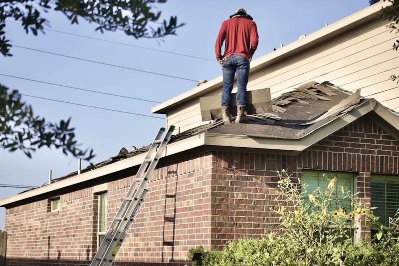 Professional roofer working on a residential roof in Rice Lake